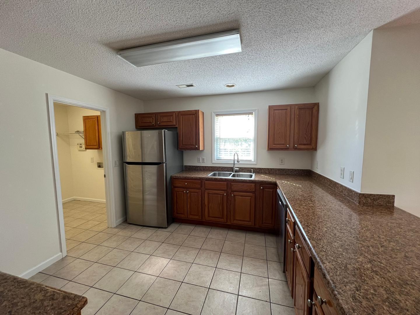 100 Dover Court East Sanford, NC 27332 - Photo 5 of 20 a kitchen with a refrigerator sink and cabinets
