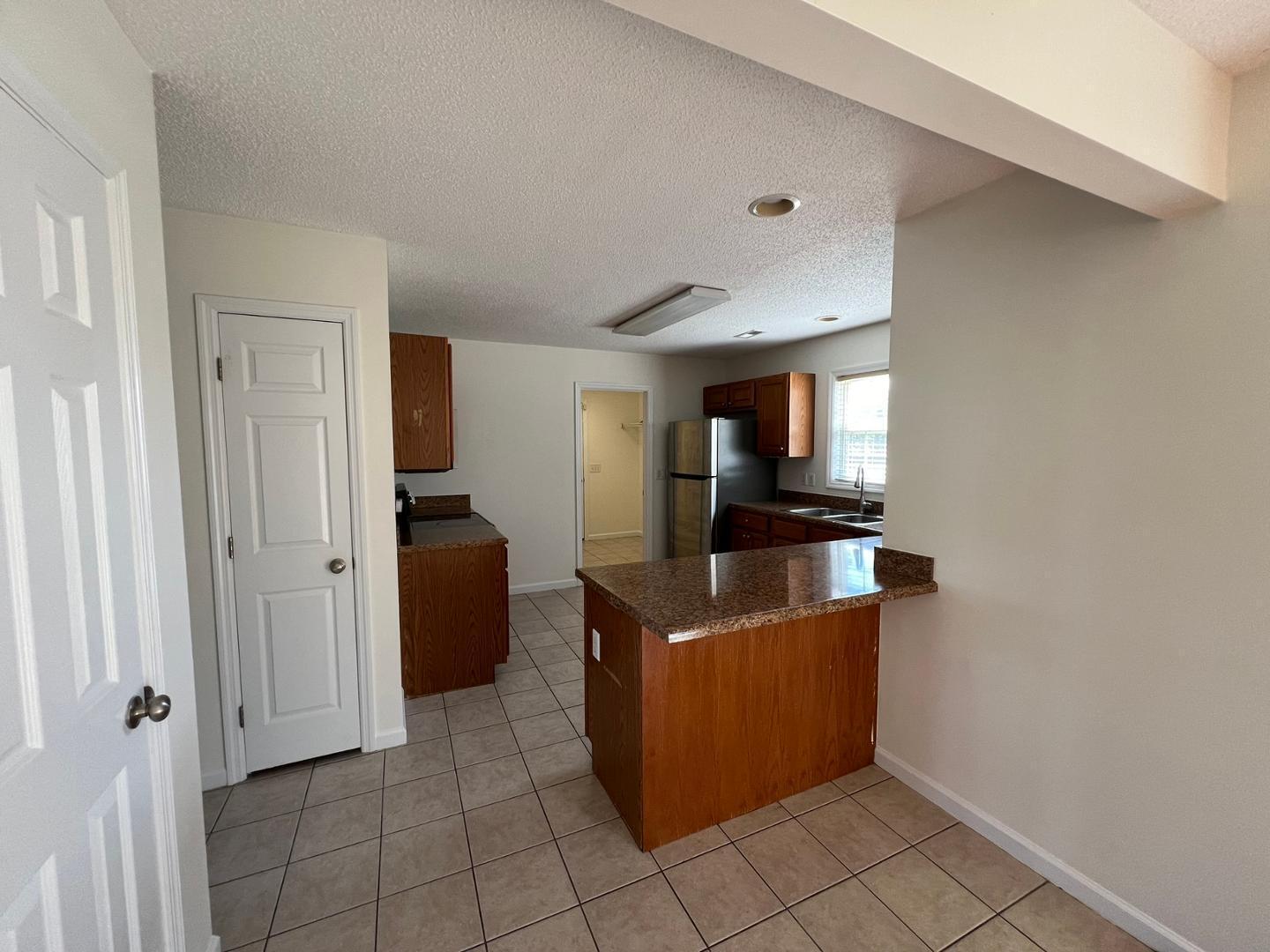 100 Dover Court East Sanford, NC 27332 - Photo 7 of 20 a view of a kitchen with an empty space and a window