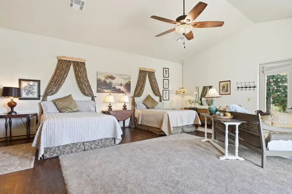 a backyard of a house with lawn chairs and wooden fence