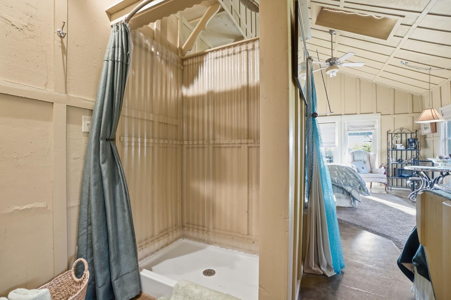 21645 Parrotts Ferry Road Sonora, CA 95370 - Photo 24 of 95 a bathroom with a glass door shower and a sink