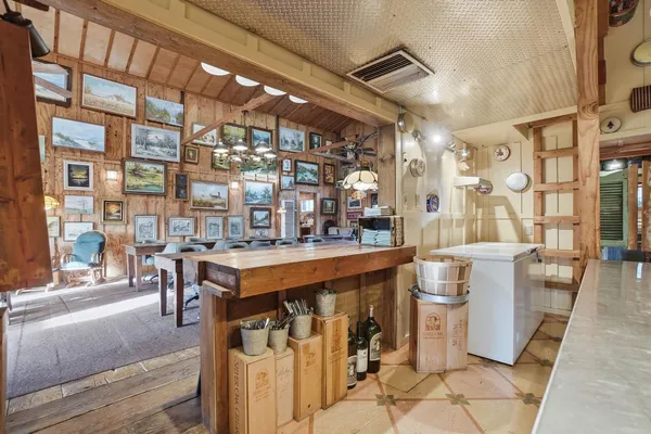 a view of dining room with wooden floor and large windows