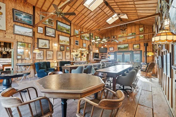 a kitchen with stainless steel appliances granite countertop a sink a stove and a wooden floors