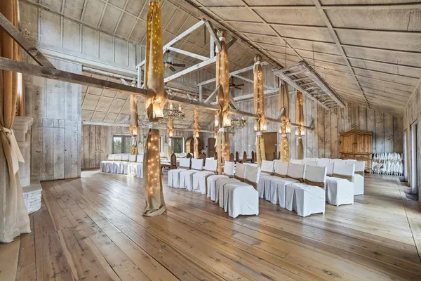 a view of a house with a large tree and a yard