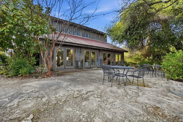 a backyard of a house with yard and outdoor seating