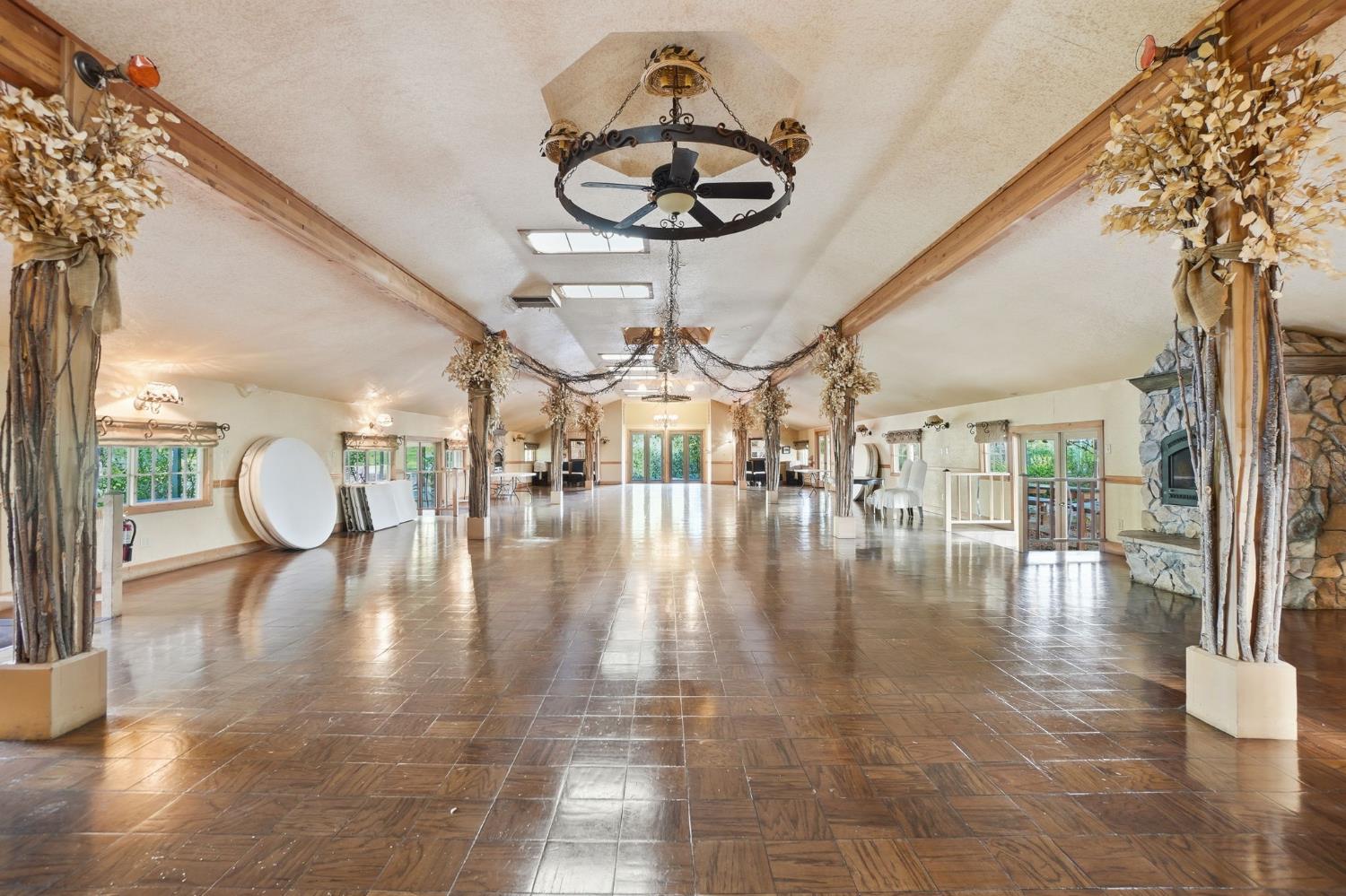 21645 Parrotts Ferry Road Sonora, CA 95370 - Photo 56 of 95 a view of dining room with wooden floor and large windows