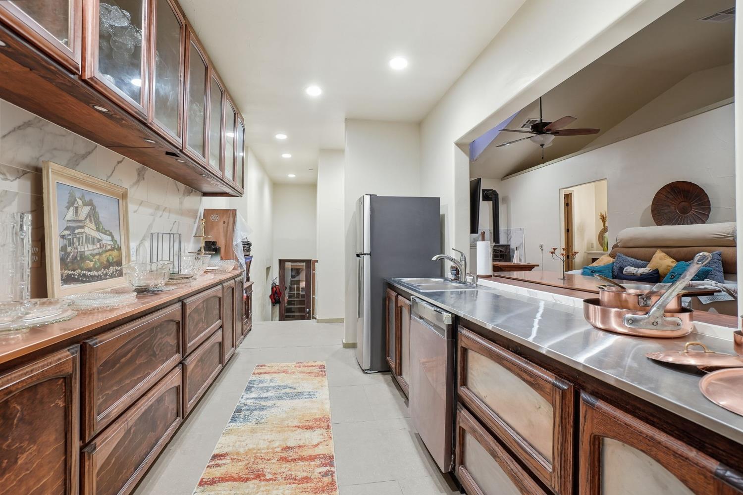 21645 Parrotts Ferry Road Sonora, CA 95370 - Photo 80 of 95 a large kitchen with stainless steel appliances granite countertop a lot of counter space and a sink