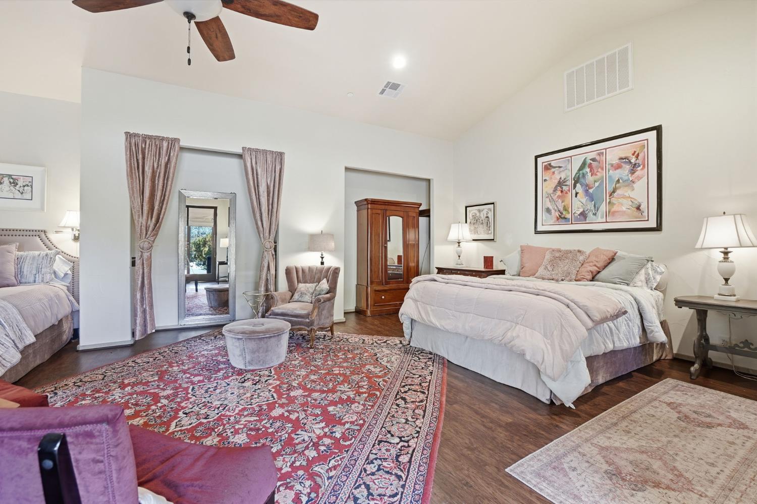 21645 Parrotts Ferry Road Sonora, CA 95370 - Photo 8 of 95 a spacious bedroom with a bed a couch and wooden floor