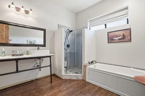 a bathroom with a sink a toilet and shower