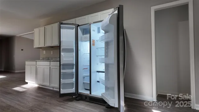 a kitchen with stainless steel appliances granite countertop a refrigerator and a stove