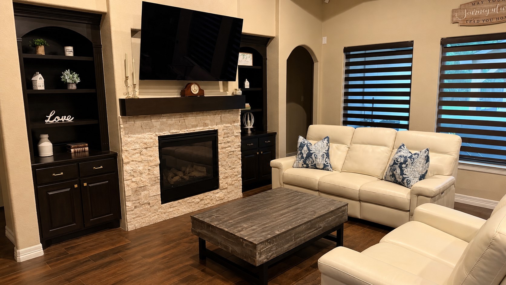 27656 Rio Blanco Drive Splendora, TX 77372 - Photo 4 of 18 This cozy living room features a modern stone fireplace, flanked by dark wood built-in shelves.