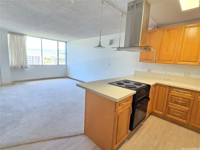 a kitchen with a stove a sink and a window