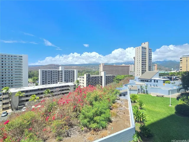a view of a house with a big yard and potted plants