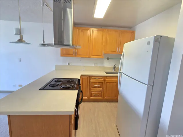 a white refrigerator freezer sitting in a kitchen