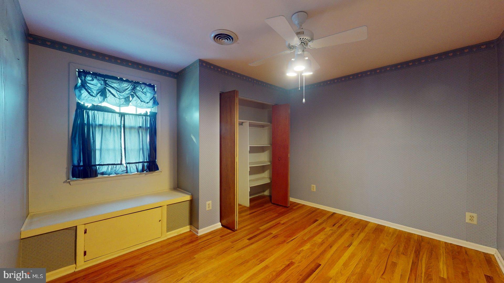 217 3rd Avenue Glendora, NJ 08029 - Photo 5 of 17 a view of an empty room with window and wooden floor