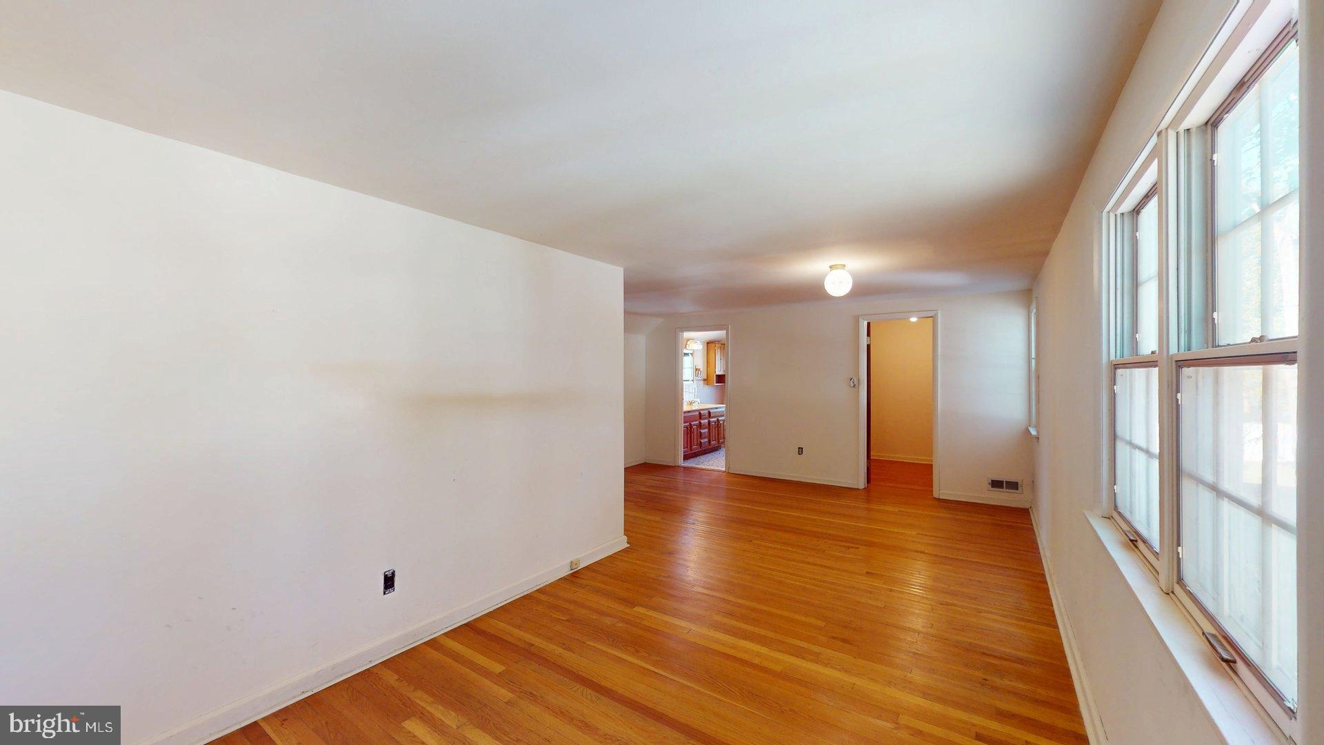 217 3rd Avenue Glendora, NJ 08029 - Photo 9 of 17 a view of an empty room with wooden floor and a window