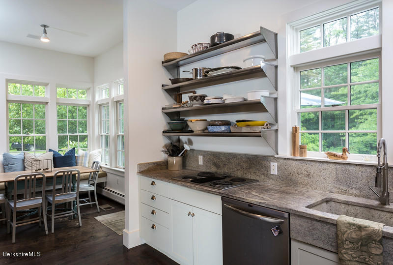 1 Mahkeenac Road Stockbridge, MA 01262 - Photo 8 of 32 a kitchen with stainless steel appliances granite countertop a stove a sink and a dining table with wooden cabinet
