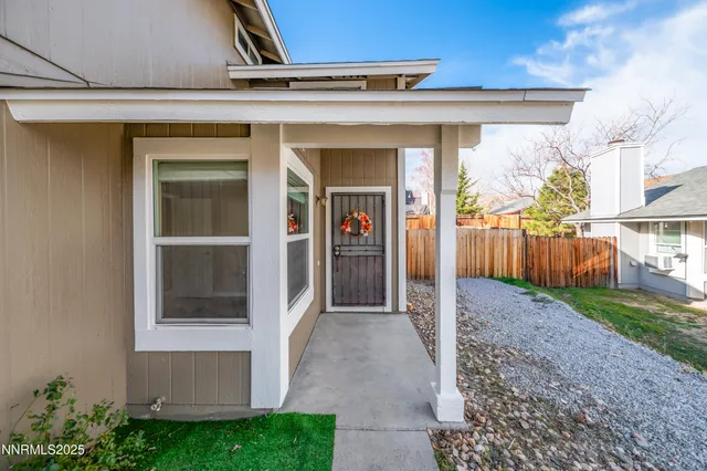 a view of a entrance gate of the house and front view of a house
