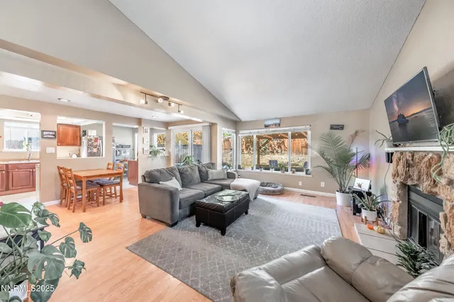 a living room with furniture large window and a fireplace