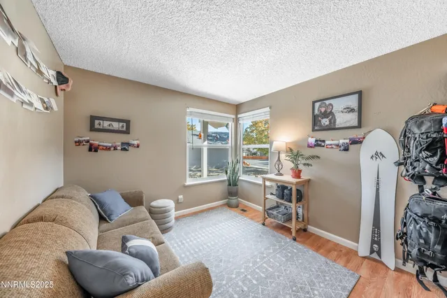 a open kitchen with stainless steel appliances granite countertop a stove a refrigerator a sink dishwasher with a dining table and chairs with wooden floor