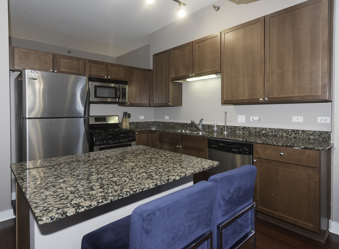 901 West Madison Street, Unit 818 Chicago, IL 60607 - Photo 12 of 26 a kitchen with a refrigerator sink and stove