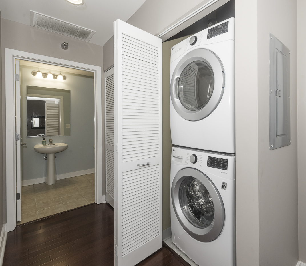 901 West Madison Street, Unit 818 Chicago, IL 60607 - Photo 18 of 26 a view of a hallway with washer and dryer