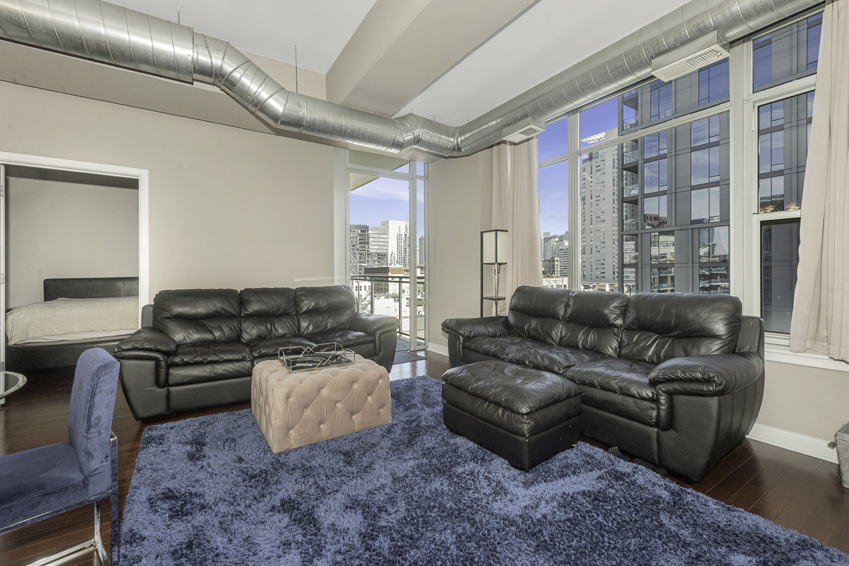 901 West Madison Street, Unit 818 Chicago, IL 60607 - Photo 2 of 26 a living room with furniture and a large window