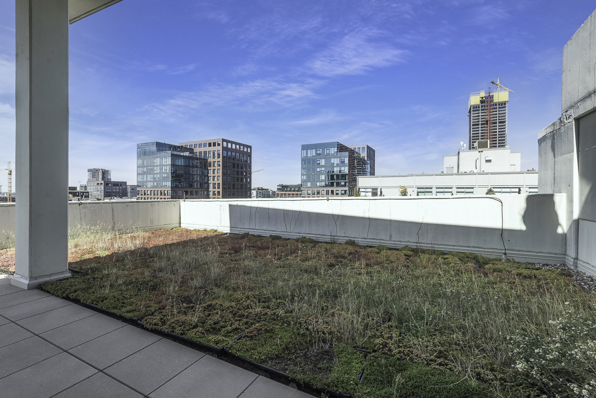 901 West Madison Street, Unit 818 Chicago, IL 60607 - Photo 24 of 26 a living room with kitchen island granite countertop furniture and a wooden floor