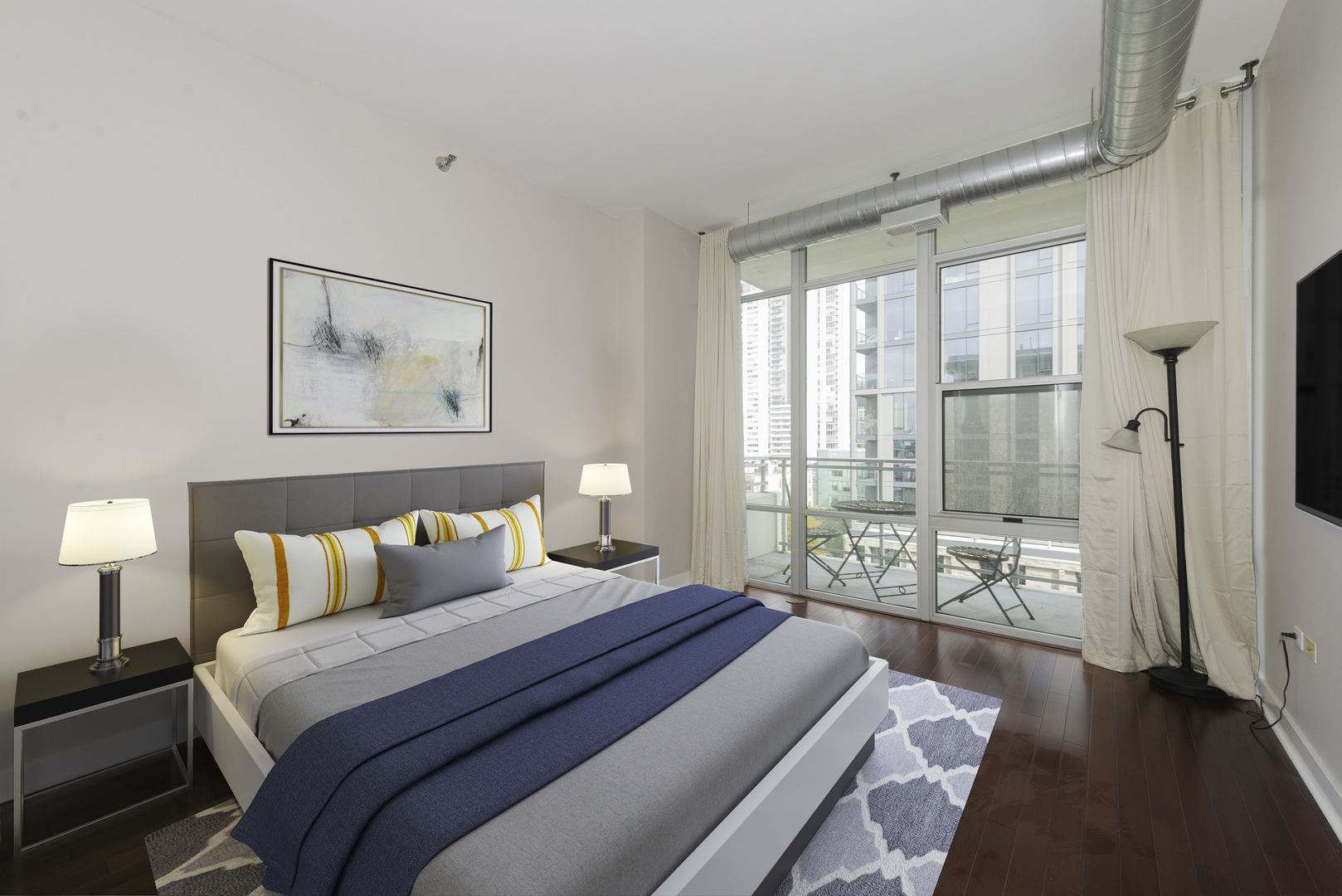 901 West Madison Street, Unit 818 Chicago, IL 60607 - Photo 5 of 26 a bedroom with a large bed and a large window