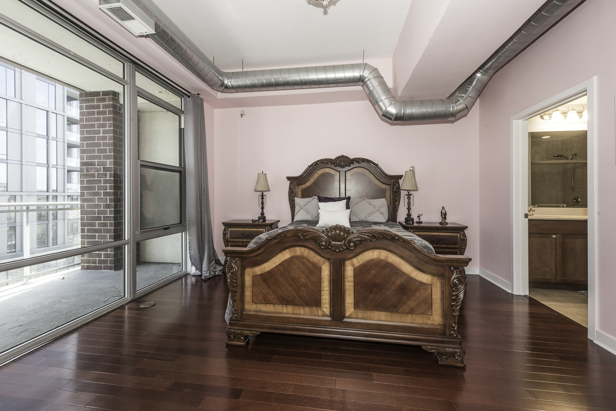 901 West Madison Street, Unit 818 Chicago, IL 60607 - Photo 8 of 26 a bedroom with a bed and wooden floor