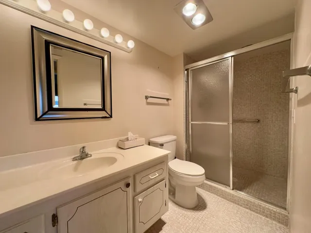a bathroom with a toilet sink and shower