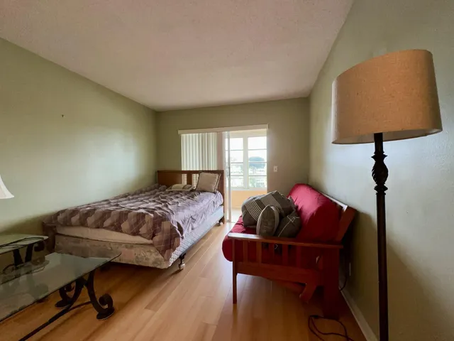 a bedroom with bed and a window