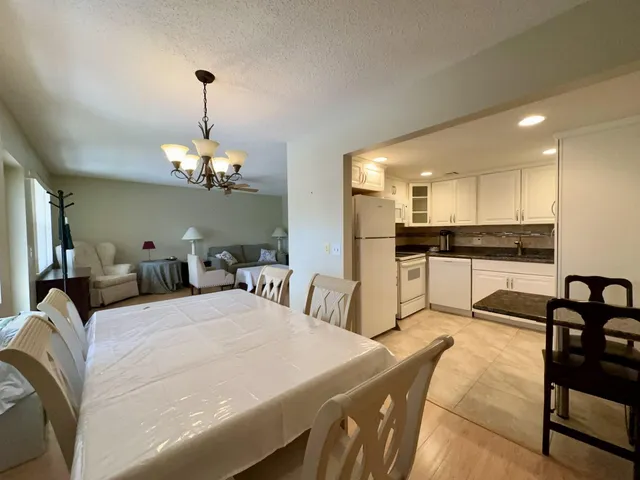 a large bedroom with bed and a chandelier
