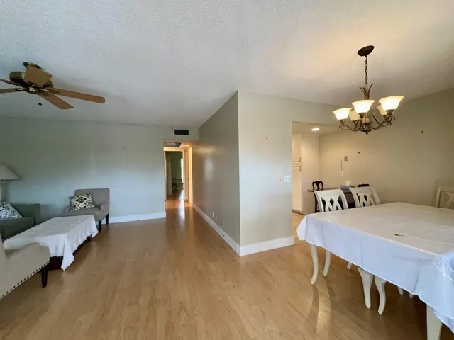 a view of a room with furniture and wooden floor