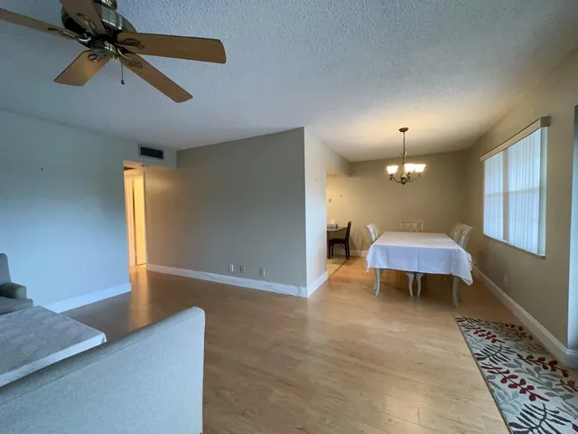 a view of a livingroom with furniture and a ceiling fan