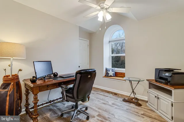 an empty room with wooden floor and gym equipment