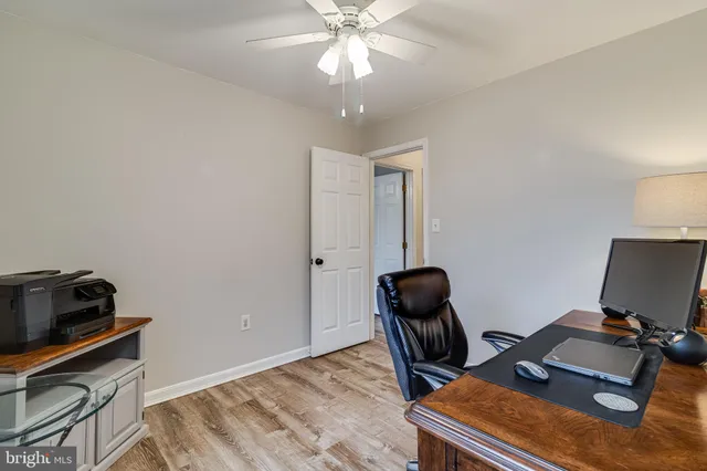 a view of a room with wooden floor and gym equipment