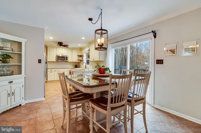 a view of a dining room with furniture wooden floor and chandelier