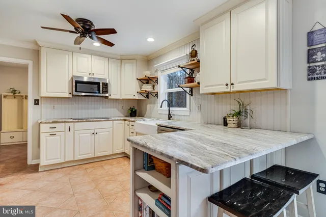 a kitchen with cabinets appliances a sink and a counter top space