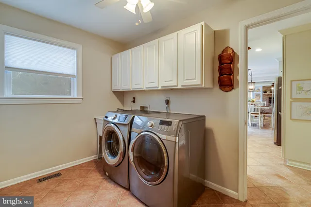 a kitchen with cabinets appliances and a window