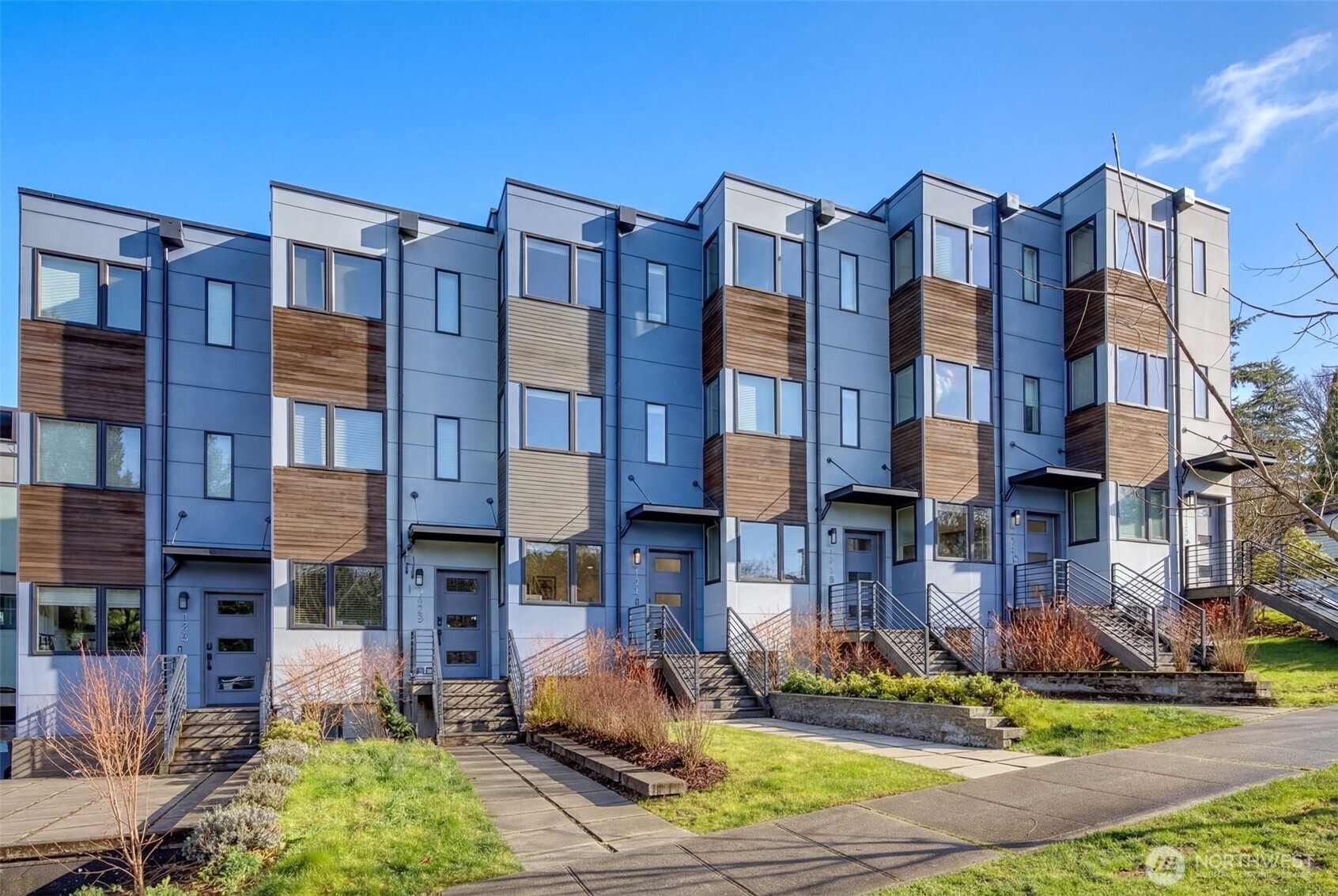 4274 Northeast 50th Street Seattle, WA 98105 - Photo 2 of 22 a front view of a residential apartment building with a yard