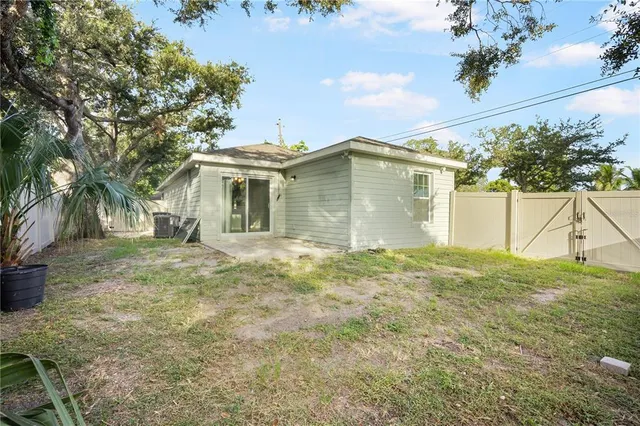 a view of a house with a backyard