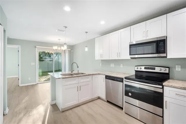 a kitchen with a sink stove and microwave