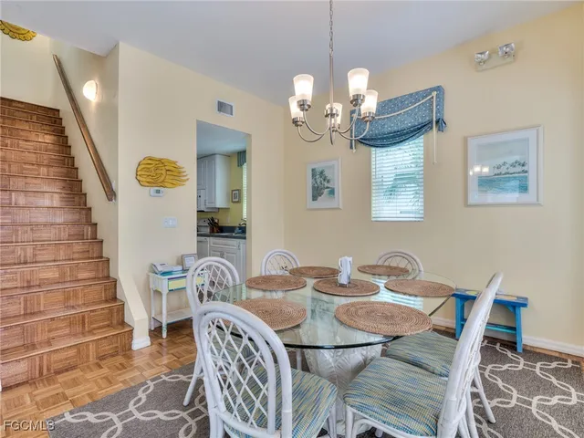a view of a dining room with furniture and chandelier