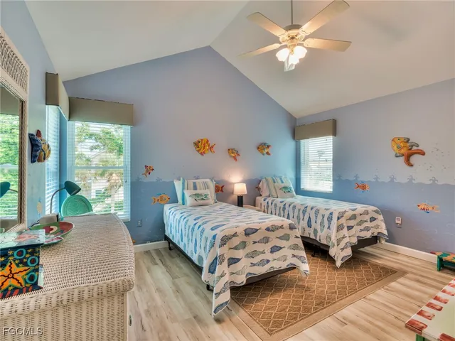 a bedroom with two beds and a large window