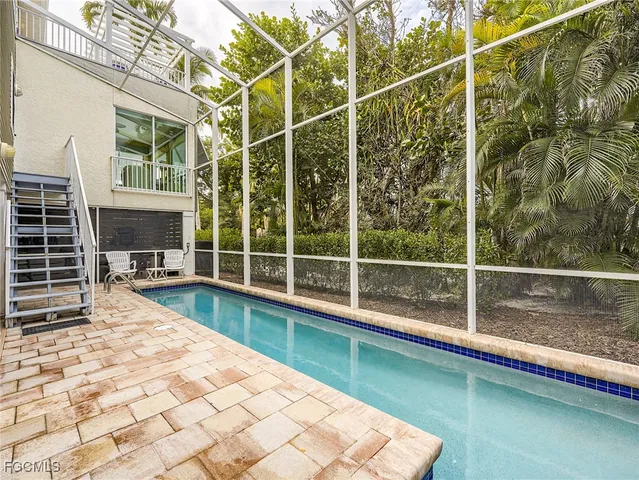 a view of a swimming pool with a lounge chair