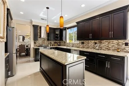 a kitchen with stainless steel appliances granite countertop a sink stove and cabinets