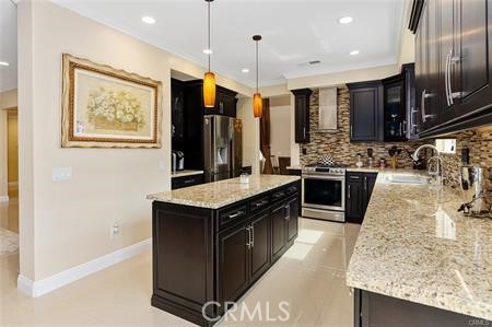25724 Lewis Way Stevenson Ranch, CA 91381 - Photo 12 of 36 a kitchen with stainless steel appliances granite countertop a stove a sink and a refrigerator