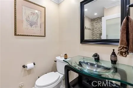 a bathroom with a sink and a mirror with toilet
