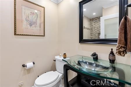 25724 Lewis Way Stevenson Ranch, CA 91381 - Photo 17 of 36 a bathroom with a sink and a mirror with toilet