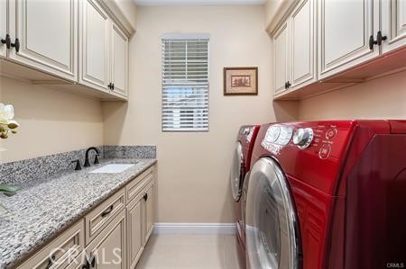 25724 Lewis Way Stevenson Ranch, CA 91381 - Photo 18 of 36 a utility room with granite countertop a sink a washer and dryer